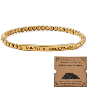 Gold stainless steel beaded bracelet with inspirational engraved bar and gift card
