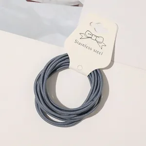 Macro view of minimalist high elastic Morandi blue thin hair tie on display card