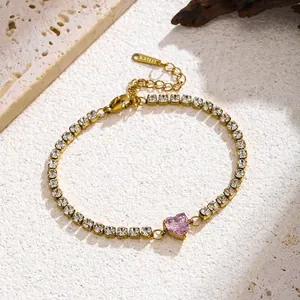 Close-up of gold stainless steel tennis bracelet with pink heart zircon