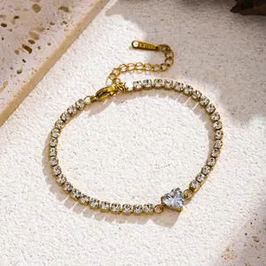 Detailed view of gold tennis bracelet featuring sparkling heart-shaped zircon stone.