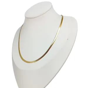 Simple 18K gold plated titanium steel flat snake chain necklace on white mannequin bust.