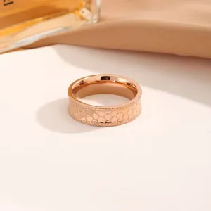 Close-up of rose gold stainless steel ring featuring a delicate honeycomb scale texture