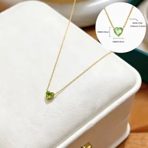 Detailed view of a gold heart birthstone necklace with a 10mm green gemstone pendant
