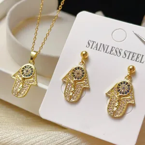 Detailansicht des vergoldeten Hamsa-Hand-Schmucksets mit blauen und weißen CZ-Steinen