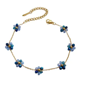 Elegant gold stainless steel necklace featuring delicate blue crystal flower accents