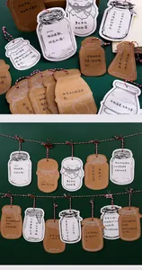 Jar-shaped decorative wish cards hanging on a red and white string for message notes