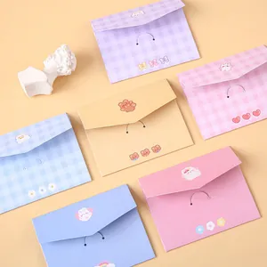 Cute cartoon bear and rabbit folding greeting cards in pastel colors on a beige background