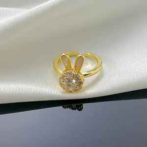 Detail of a gold-plated rabbit ring with shimmering CZ stones and shell-like ear accents.