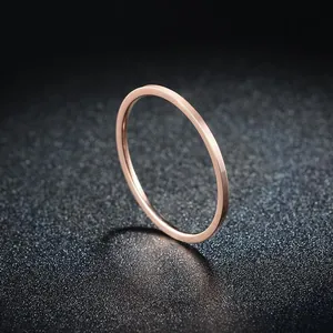 Close-up of minimalist rose gold slim titanium steel ring on glitter background
