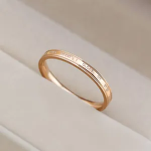 Macro view of a minimalist rose gold ring engraved with 'WHEN I CLOSE MY EYES'