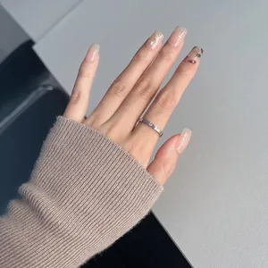 Macro view of minimalist silver titanium steel ring with fine letter engraving on band