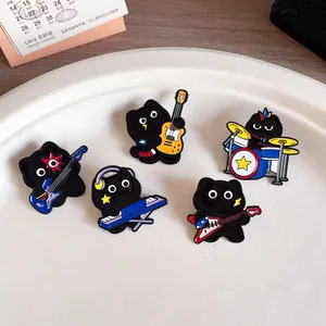 Set of five cute black cat band enamel pins featuring guitar, drum, and piano designs