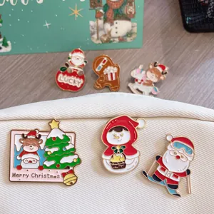 Detailed shot of festive Christmas enamel pins featuring Santa, reindeer and snowmen.