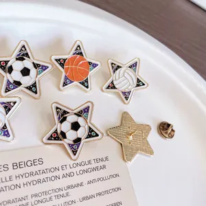 Detailed view of star-shaped enamel pins featuring soccer, basketball, and volleyball designs.