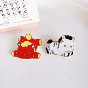 Detailed close-up view of cute horse and zebra metal enamel pins on a white background.