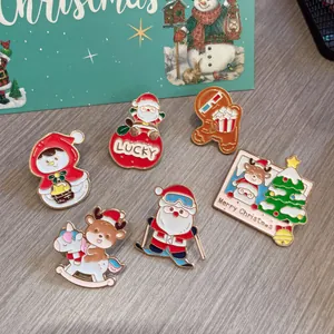 Detailed view of cute Christmas enamel pins featuring Santa, reindeer and snowman.