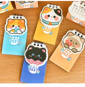 Vibrant 2027 mini desk calendars featuring assorted cute cartoon cat illustrations