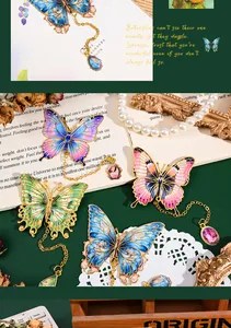 Detailed view of colorful butterfly metal bookmarks with delicate hanging charms on green background