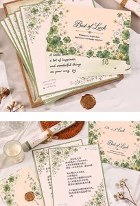 Detail of plant-themed stationery set featuring four-leaf clover prints and wax seal
