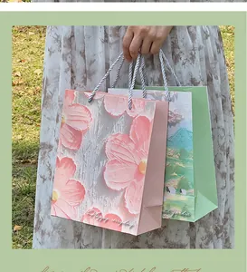 Detail view of high-end creative oil painting gift paper bags with floral and landscape designs.