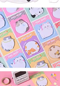 Detailed view of cute cartoon cat sticky notes in various designs with desk props