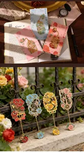Detailed view of intricate floral metal bookmarks with rose motifs and hanging chains.