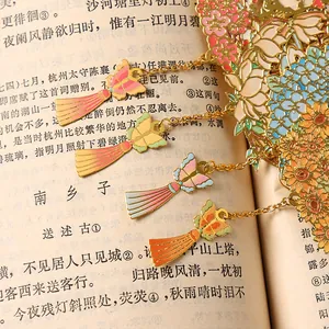 Intricate hollow floral metal bookmark featuring colorful enamel butterflies and tassels