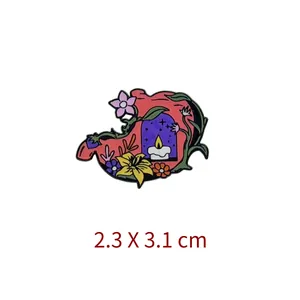 Macro detail view of an artistic floral stomach enamel pin showing 2.3 x 3.1 cm dimensions
