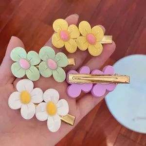 Close-up of colorful flower hair clips set in yellow, green and white candy colors
