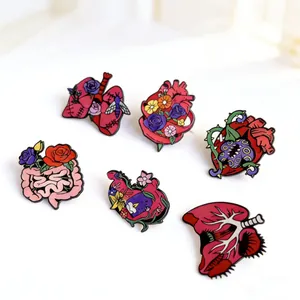 Set of artistic floral anatomical organ enamel pins with heart and lung designs