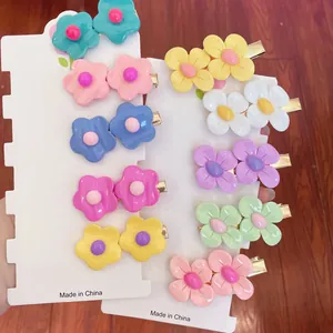 Candy color flower hair clips set on white display card with gold metal duckbill clip backings.