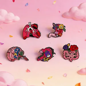 Floral anatomical enamel pins set featuring detailed lungs, brain, heart, and stomach designs