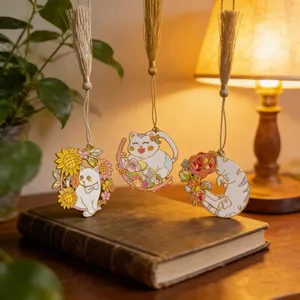 Detailed view of three cat-shaped metal bookmarks with tassels on a vintage book cover.