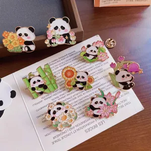 Collection of cute panda enamel pins with floral designs and bamboo elements.