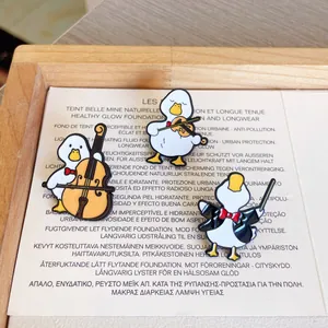 Detailed shot of cartoon duck music band enamel pins with musical instruments