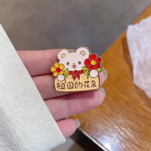 Close-up of a cute cartoon bear enamel pin with 'Flowers of the Motherland' text.