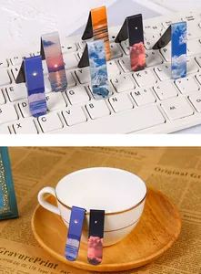 Detailed view of magnetic landscape bookmarks showing decorative usage on a cup