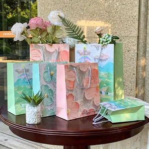 Premium oil painting style paper gift bags with elegant floral and landscape designs.