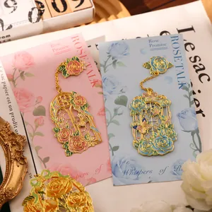 Elegant rose-themed metal bookmark with intricate floral enamel design and backing card.