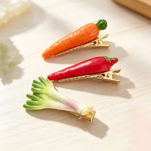 Close-up of simulation vegetable hair clips featuring carrot, chili, and onion designs.