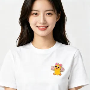 Close-up of a cute cheerleader duck enamel pin on a white t-shirt for decoration.