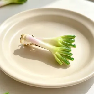 Realistic scallion vegetable hair clip on a minimalist beige ceramic plate detail view
