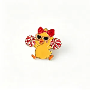 Detailed view of a cute cheerleader duck enamel pin with red bow and sunglasses