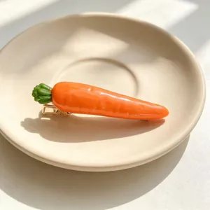 Detailed view of a realistic orange carrot hair clip on a beige ceramic saucer