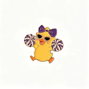 Detailed view of a cute cheerleader duck enamel pin with purple bow and sunglasses.