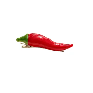 Realistic red chili pepper hair clip with green stem and metal duckbill clip design.