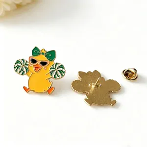 Detailed macro view of a cute cheerleader duck enamel pin with golden metal backing