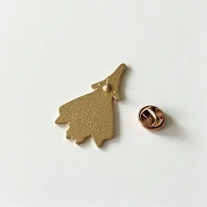 Close-up detail of gold-colored space fighter metal pin back with a butterfly clutch