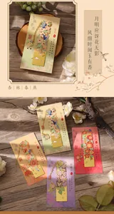 Intricate hollow-out metal bookmarks with floral and bird motifs on decorative cards