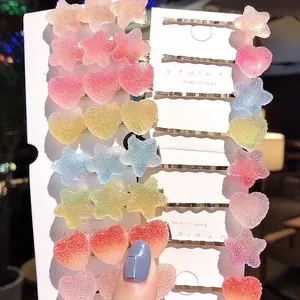 Detail shot of colorful gradient gummy heart and star hair clips on white display cards